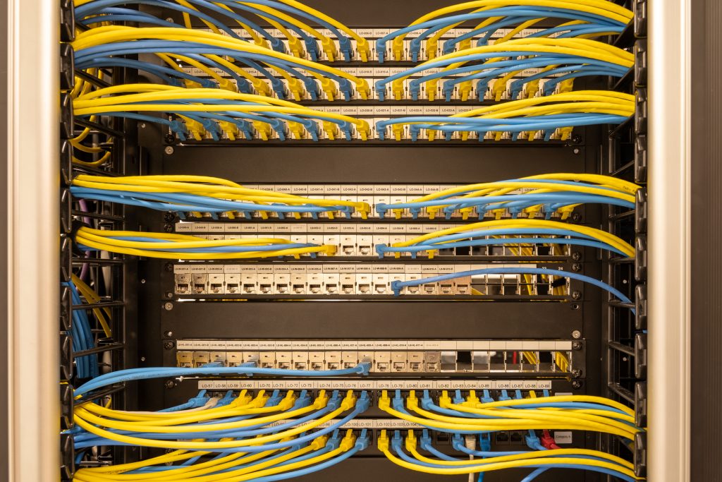 Tidy patched network cables, RJ45, connected to the switches and routers, data centre